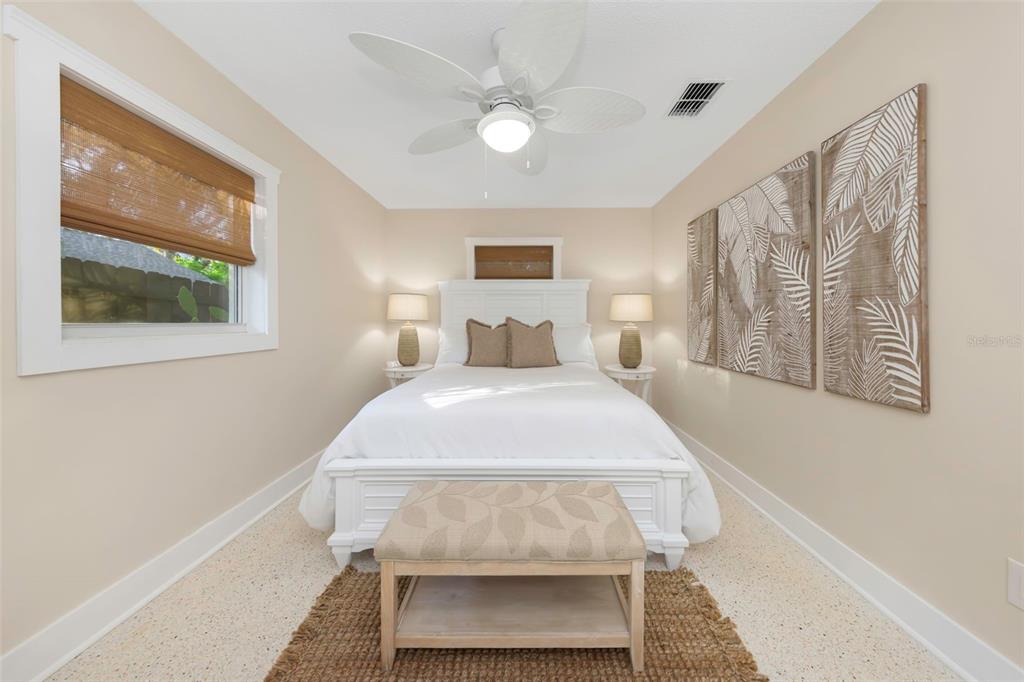 116 Read Street Tarpon Springs, FL 34689 - Photo 38 of 49 a bedroom with a bed and a painting on the wall