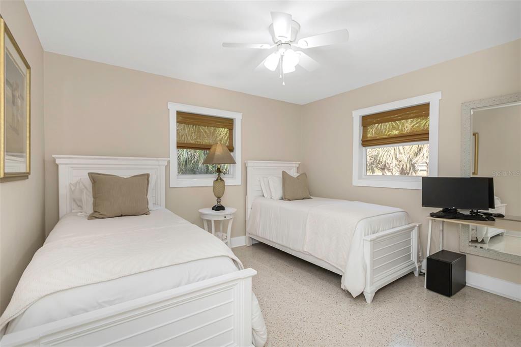 116 Read Street Tarpon Springs, FL 34689 - Photo 42 of 49 a bedroom with a bed flat screen tv and chandelier