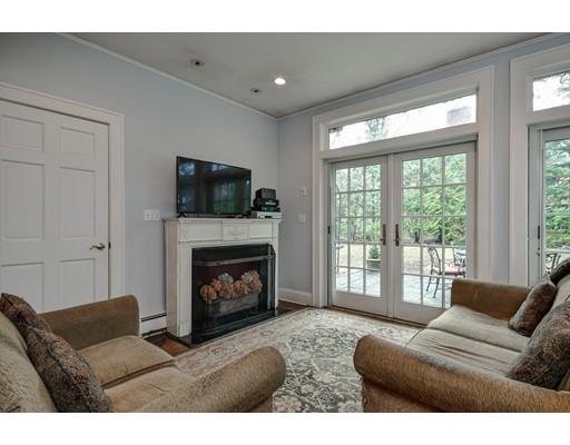 44 Bay State Road Wellesley, MA 02481 - Photo 13 of 15 a living room with furniture a flat screen tv and a fireplace