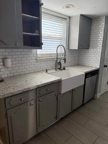 a kitchen with a sink and cabinets