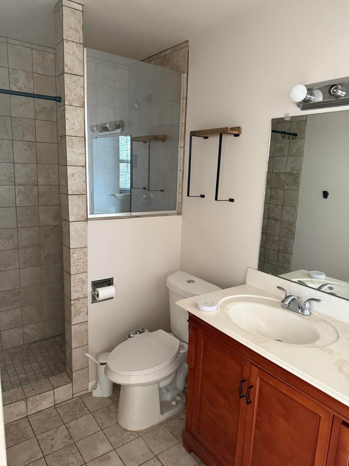 11210 Sageoak Drive Houston, TX 77089 - Photo 15 of 18 a bathroom with a sink mirror vanity and toilet