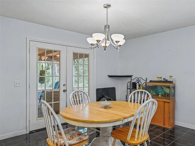 a view of a dining room with furniture wooden floor and chandelier