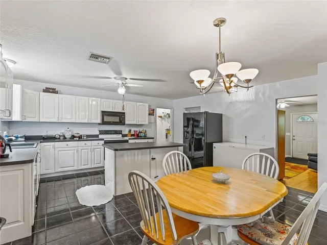 a large kitchen with a table and chairs