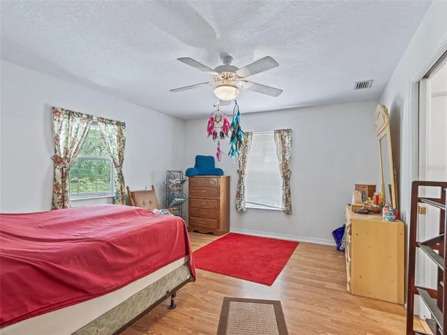a bedroom with a bed dresser and a window