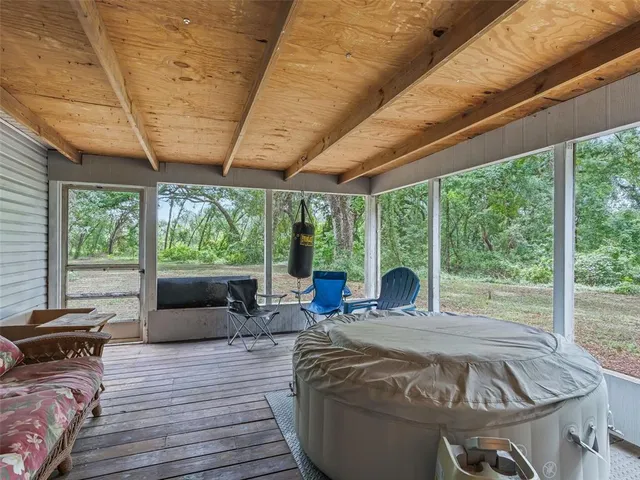 a large bed sitting in a room next to a large window with outer view