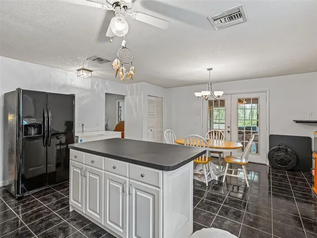 a kitchen with stainless steel appliances granite countertop a sink a counter space and a window