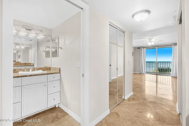 a spacious bathroom with a granite countertop sink mirror and bathtub