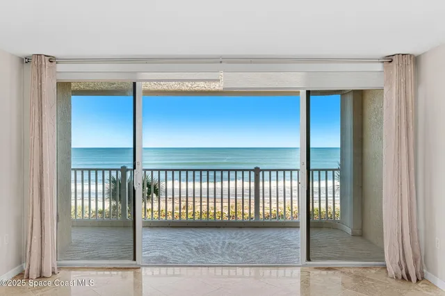 an empty room with floor to ceiling window