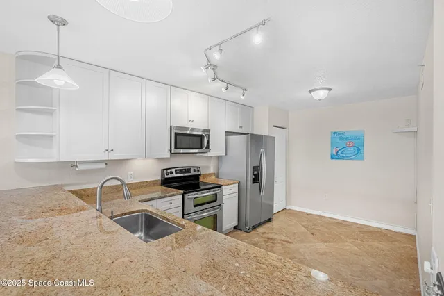 a kitchen with a sink stainless steel appliances and cabinets