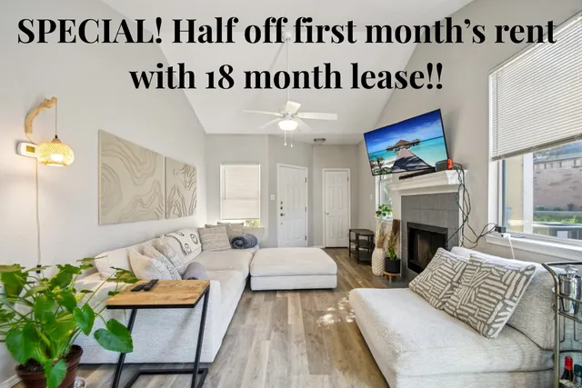 a view of living room with furniture and a fireplace