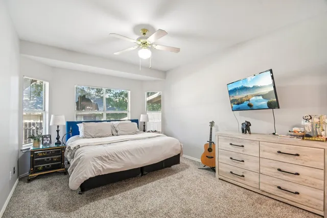 a bedroom with a bed and a dresser in it