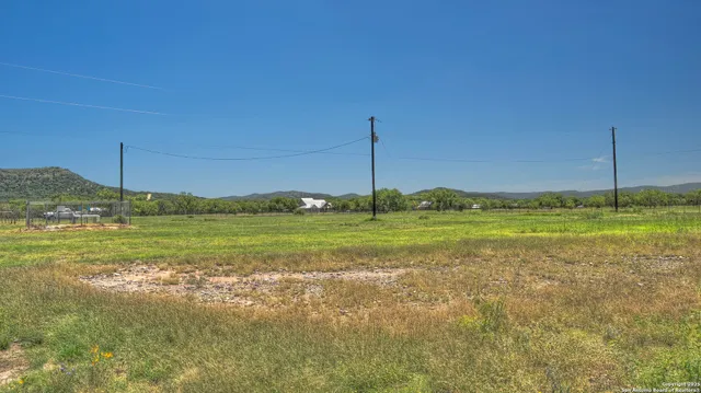 a view of a field with an ocean view