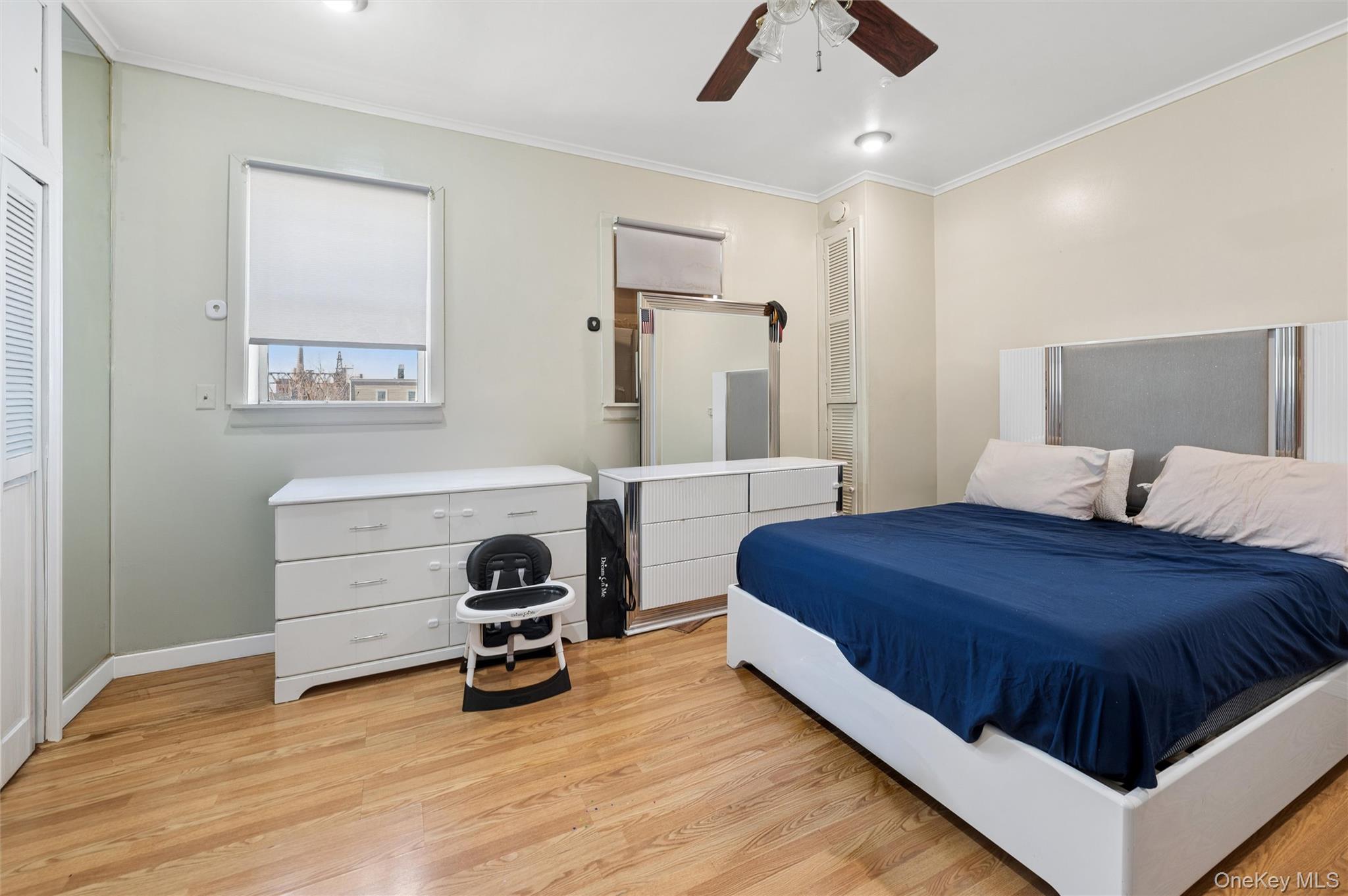 976 Sacket Avenue Bronx, NY 10462 - Photo 16 of 20 a bedroom with a bed and a ceiling fan
