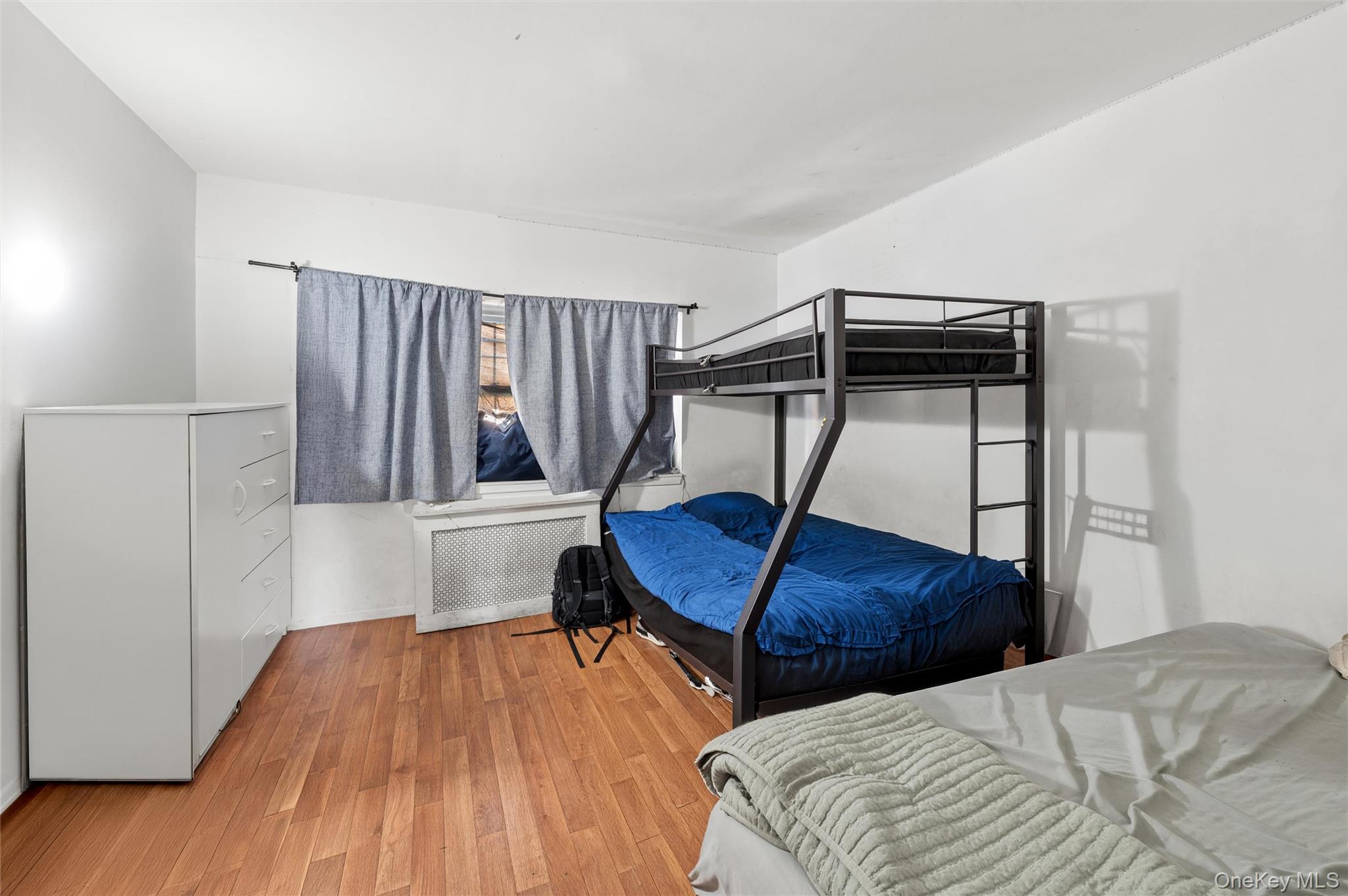 976 Sacket Avenue Bronx, NY 10462 - Photo 18 of 20 a bedroom with two beds and a wooden floor