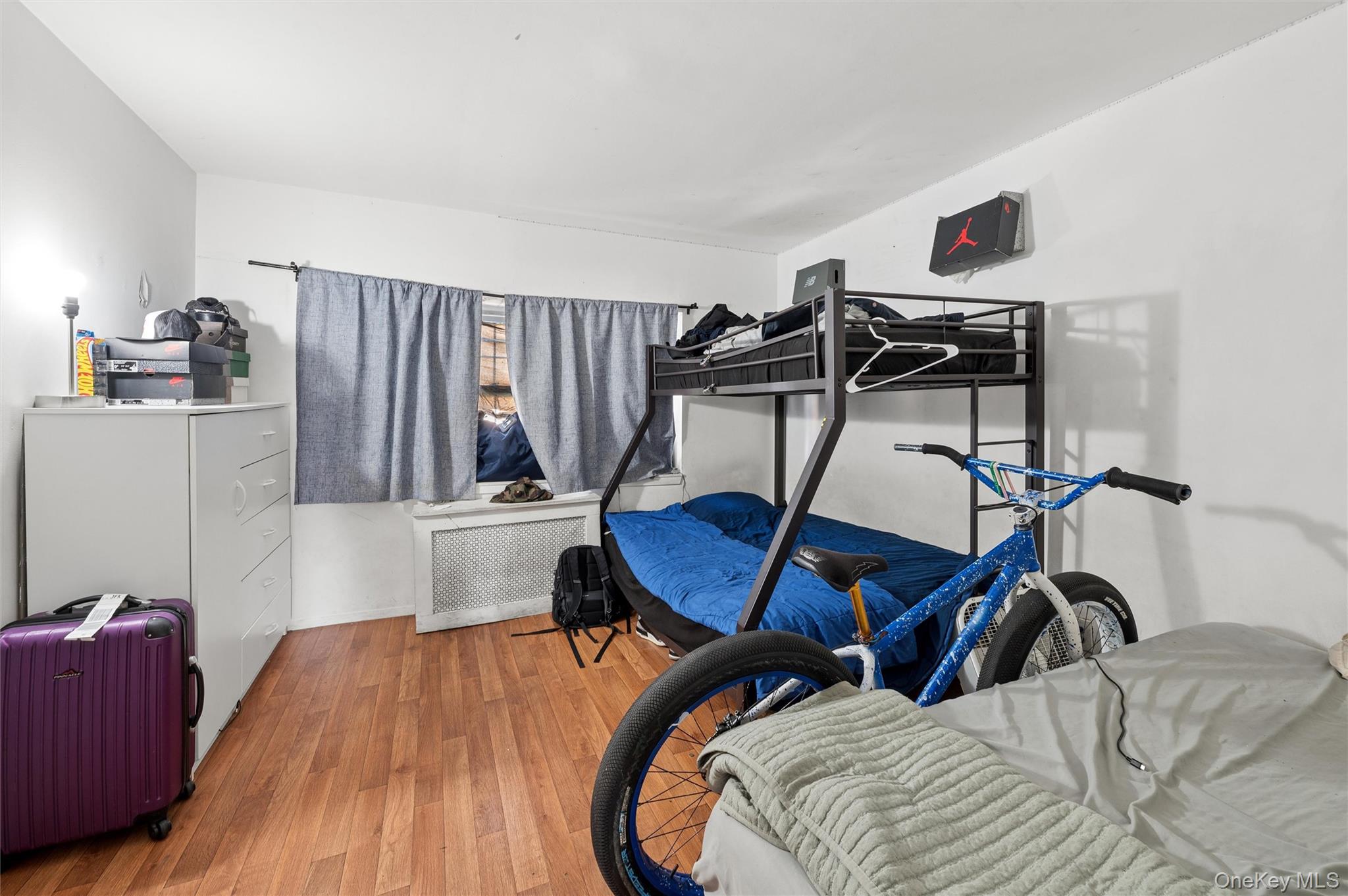 976 Sacket Avenue Bronx, NY 10462 - Photo 19 of 20 a bedroom with furniture and a wooden floor