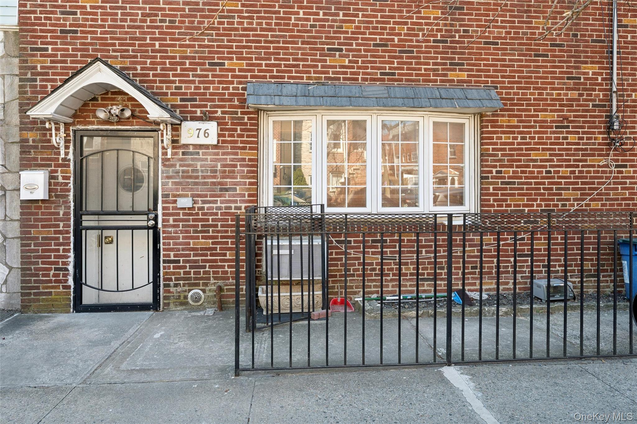 976 Sacket Avenue Bronx, NY 10462 - Photo 2 of 20 a front view of a house with a gate