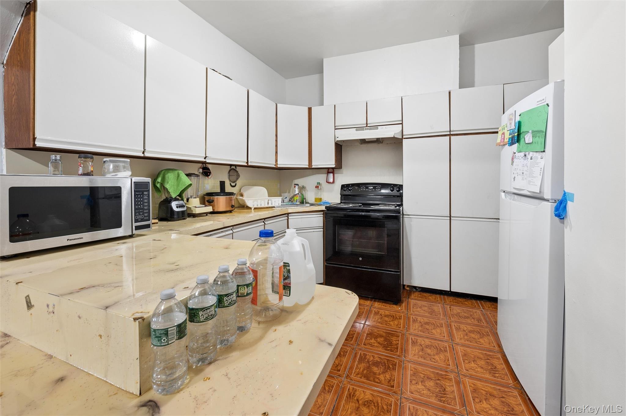 976 Sacket Avenue Bronx, NY 10462 - Photo 8 of 20 a kitchen with stainless steel appliances granite countertop a refrigerator sink and stove