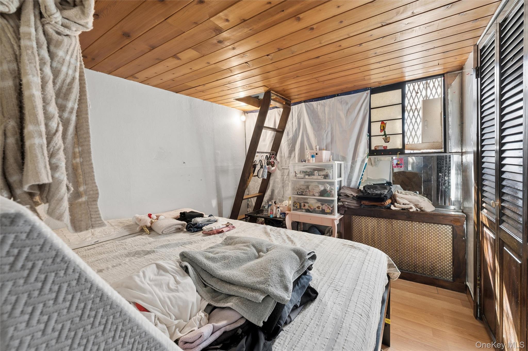 976 Sacket Avenue Bronx, NY 10462 - Photo 10 of 20 a bedroom with a bed and wooden floor