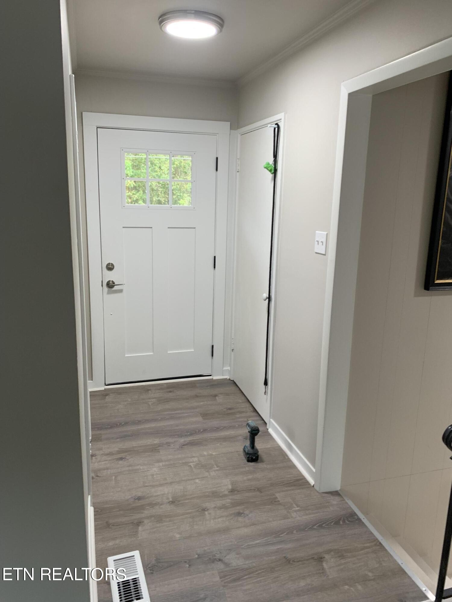 102 Audubon Road Oak Ridge, TN 37830 - Photo 2 of 19 an empty room with wooden floor and window