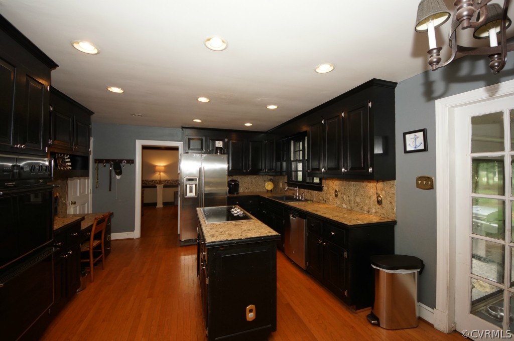 2400 Castlebridge Road Midlothian, VA 23113 - Photo 3 of 12 a kitchen with stainless steel appliances granite countertop a sink a stove and a refrigerator
