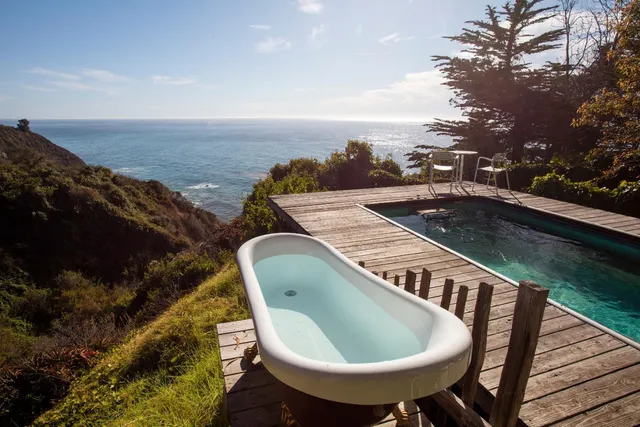 a view of a balcony with wooden floor and outdoor space