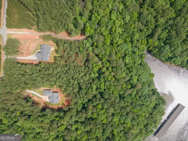 a backyard of a house with a yard and outdoor seating