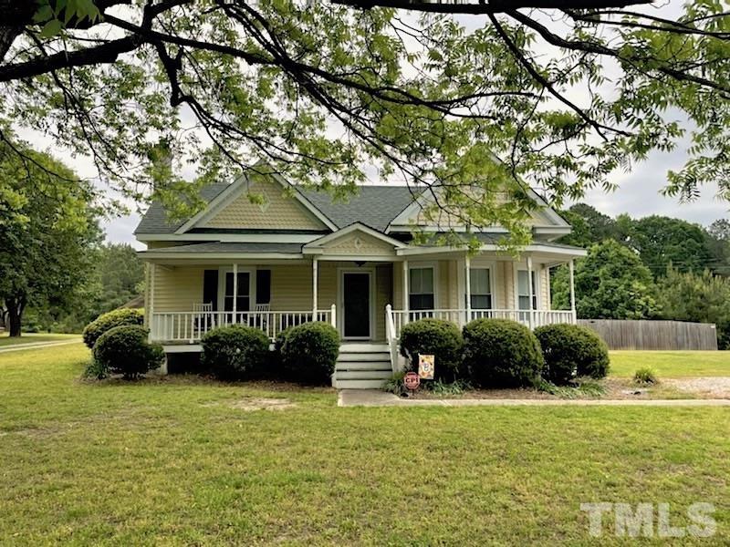 8837 Ransdell Road Raleigh, NC 27603 - Photo 1 of 48 a front view of a house with a garden