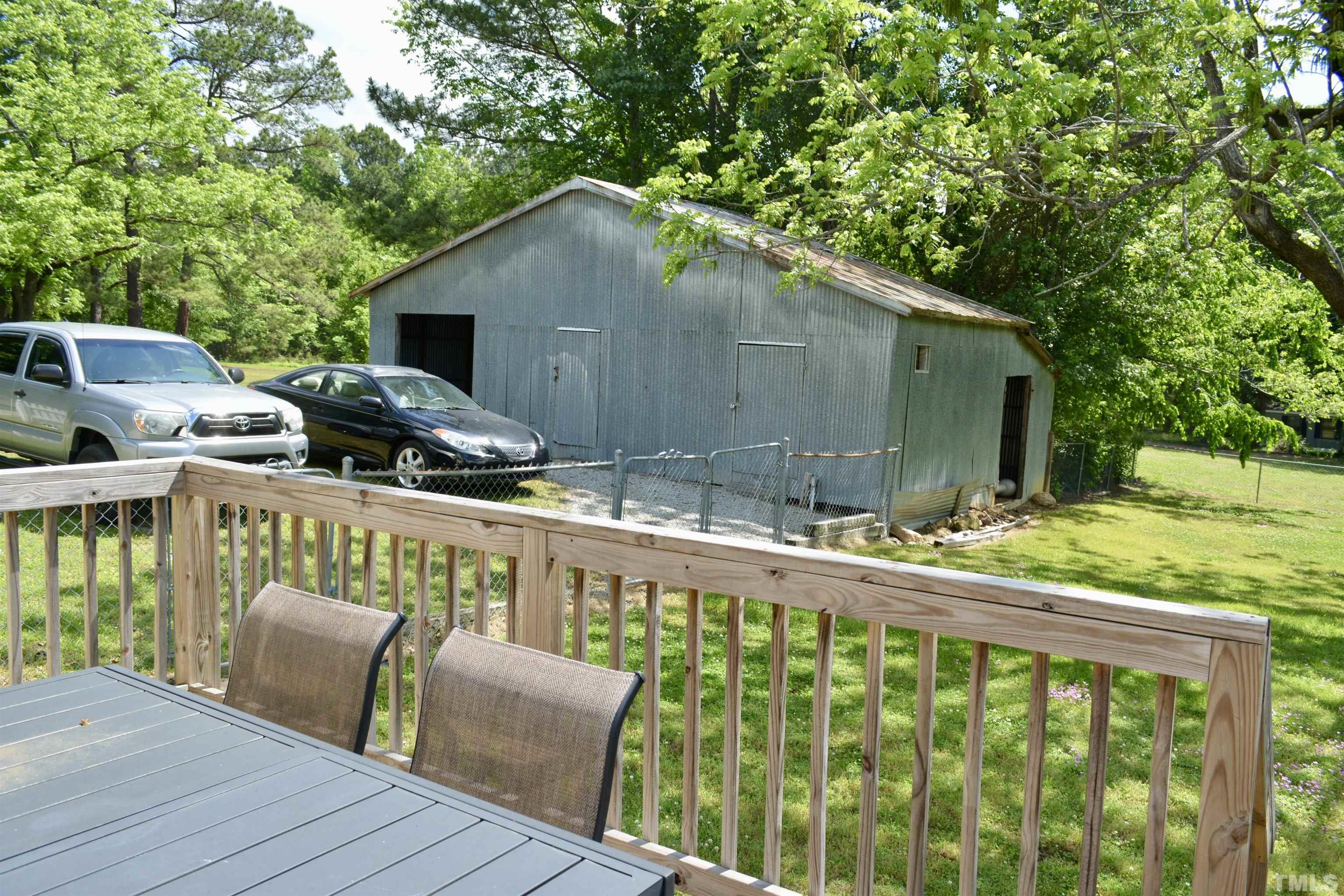 8837 Ransdell Road Raleigh, NC 27603 - Photo 13 of 48 a balcony with wooden floor and outdoor seating