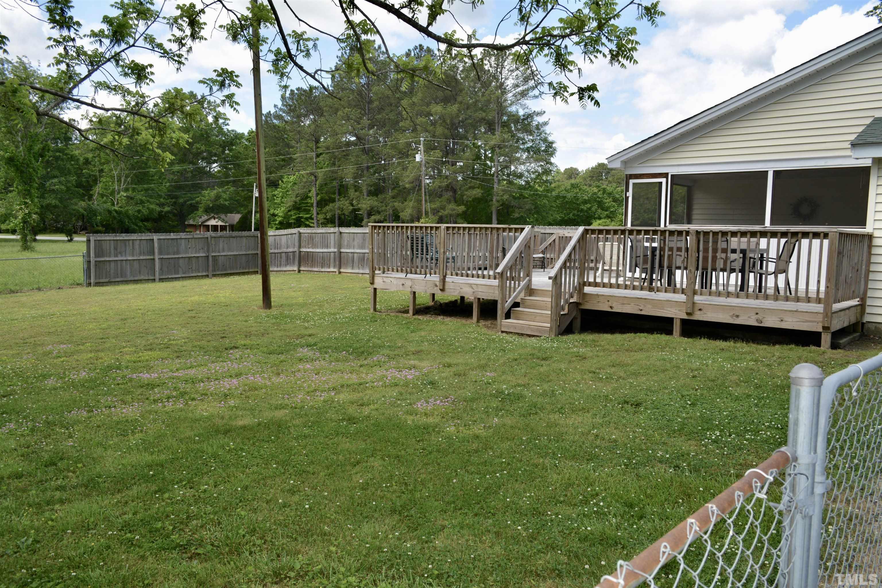 8837 Ransdell Road Raleigh, NC 27603 - Photo 21 of 48 a view of house with a backyard and deck