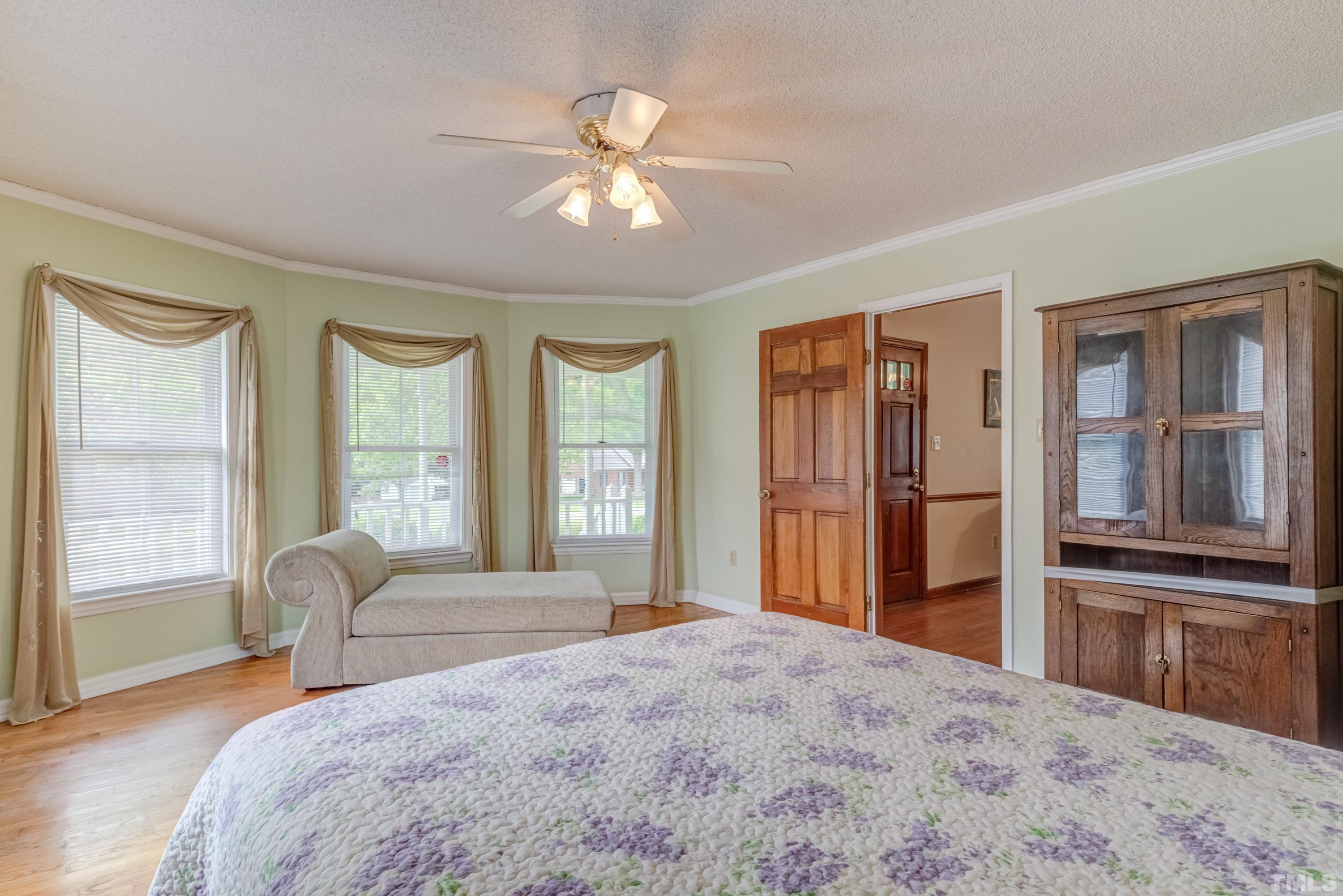 8837 Ransdell Road Raleigh, NC 27603 - Photo 25 of 48 a bedroom with a bed and a large window with balcony view