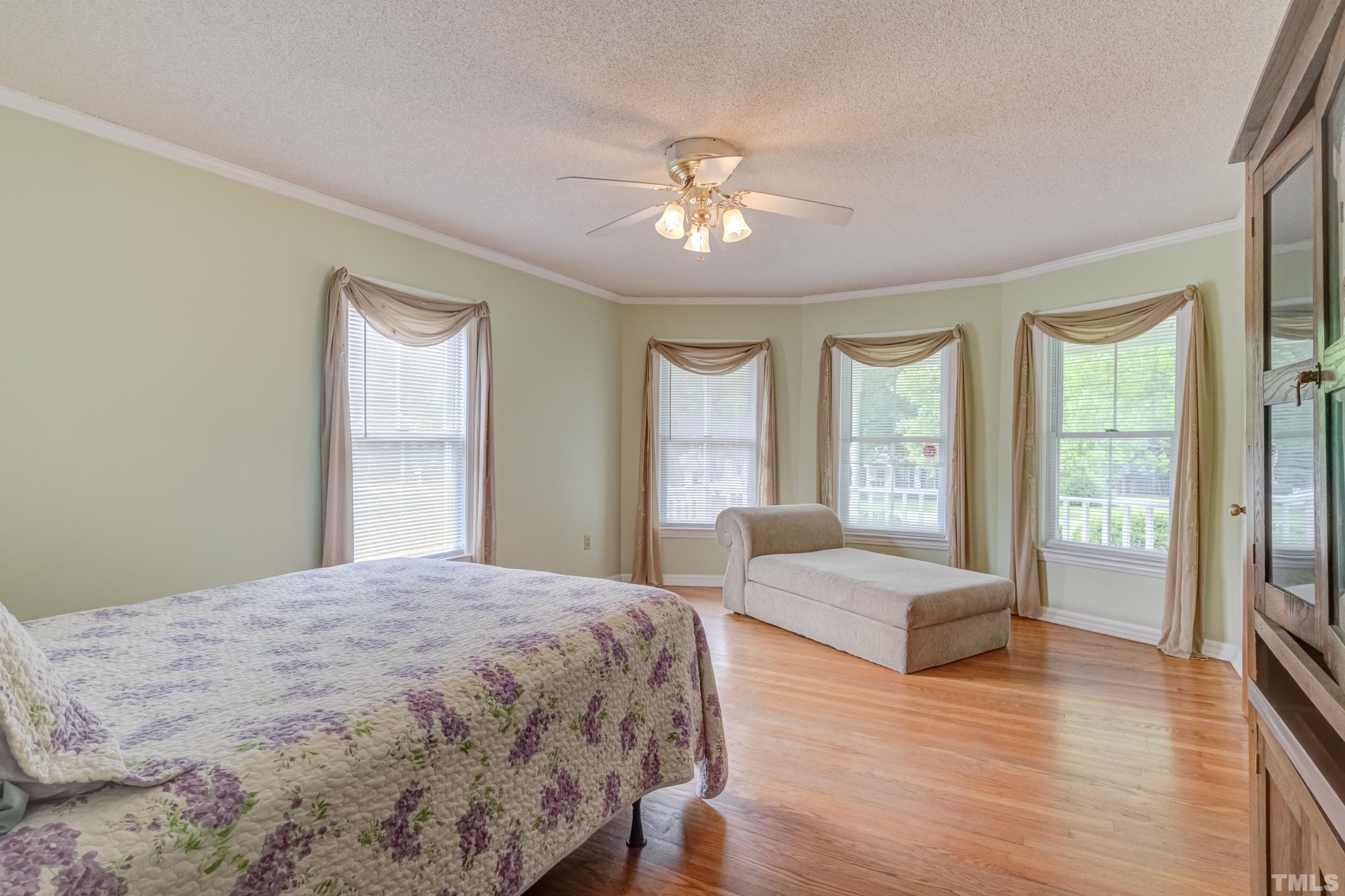 8837 Ransdell Road Raleigh, NC 27603 - Photo 29 of 48 a bedroom with a large bed and a large window