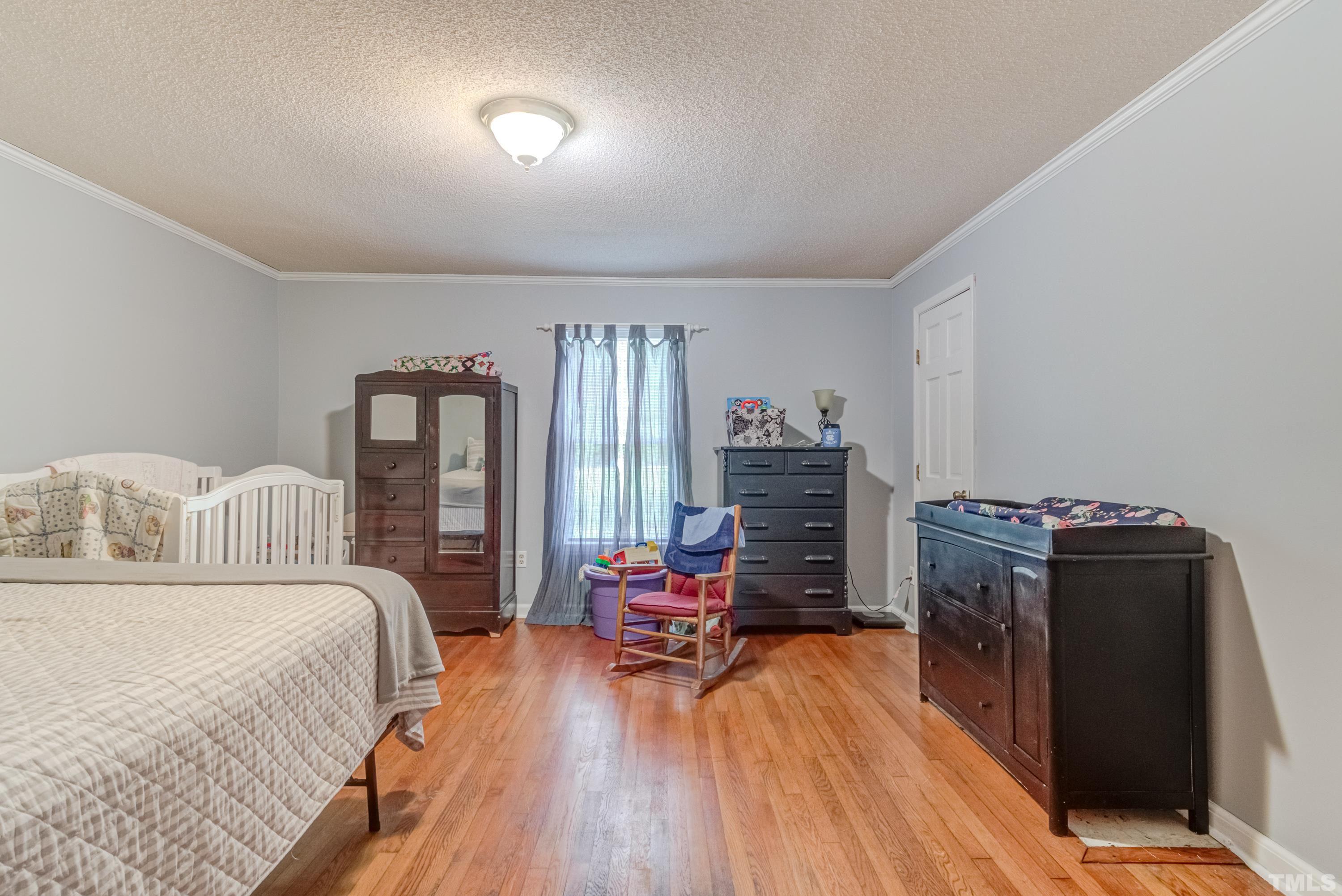 8837 Ransdell Road Raleigh, NC 27603 - Photo 31 of 48 a bedroom with furniture and wooden floor