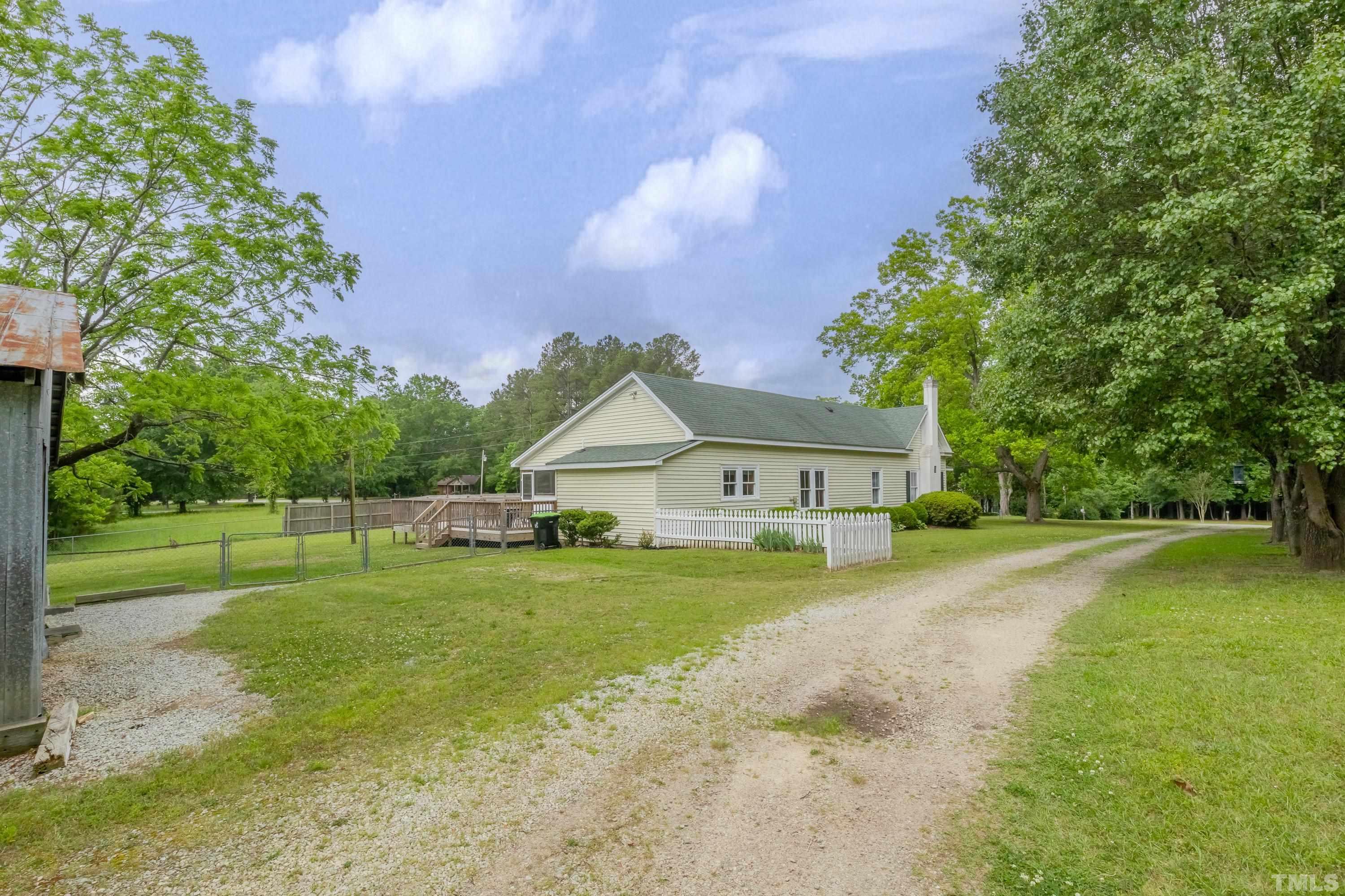 8837 Ransdell Road Raleigh, NC 27603 - Photo 41 of 48 a view of a house with a big yard and a large tree