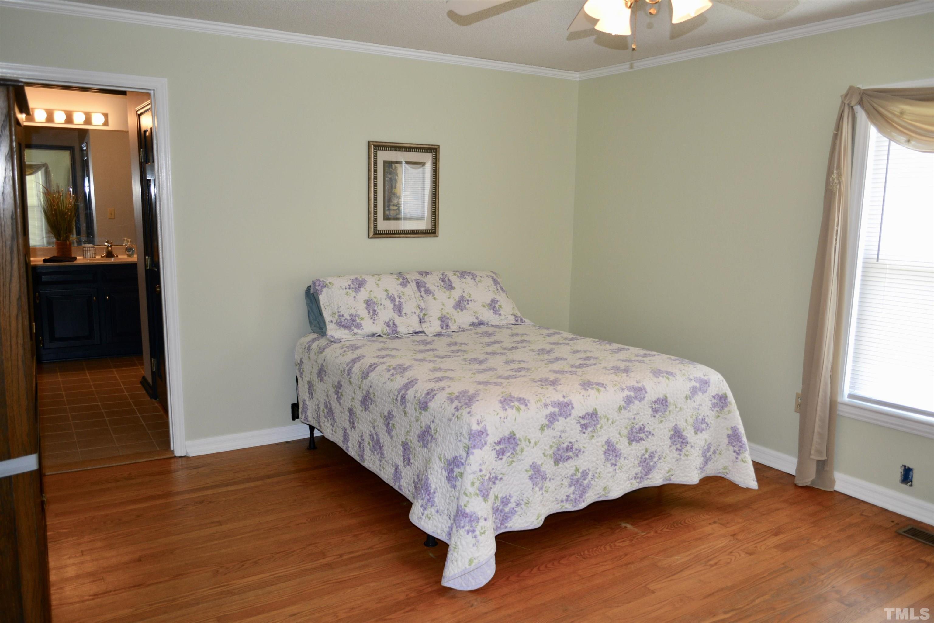 8837 Ransdell Road Raleigh, NC 27603 - Photo 8 of 48 a bedroom with a bed and a window