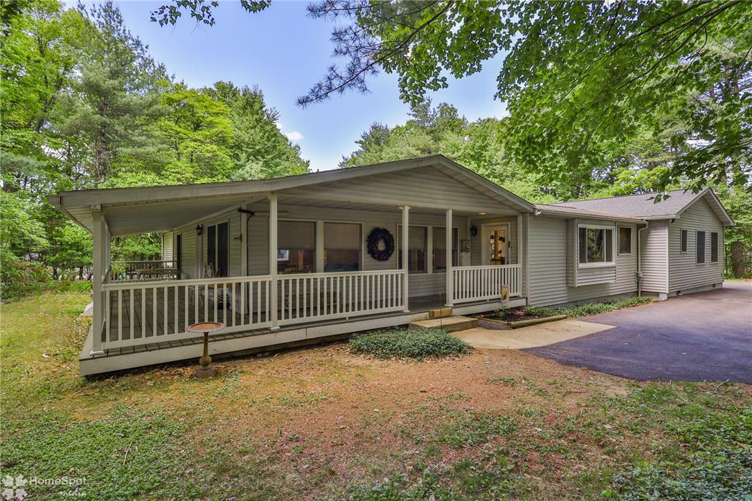 60 Sassafras Road Lehighton, PA 18235 - Photo 1 of 36 A charming single-story residence is nestled among mature trees, boasting a welcoming covered porch.