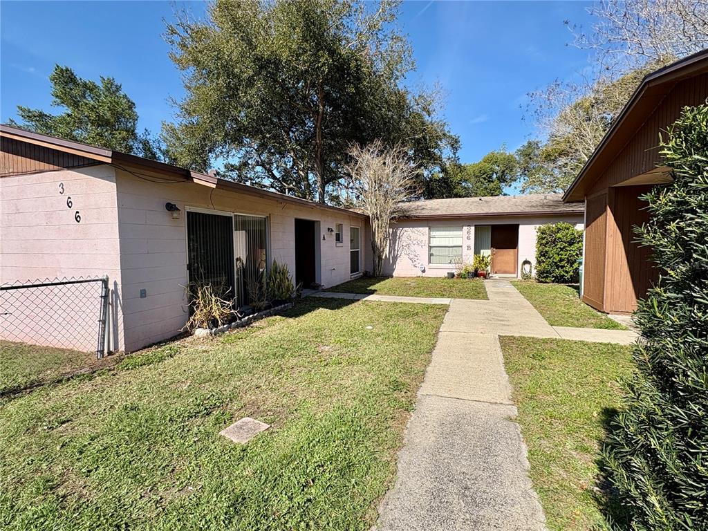 a view of house with yard and entertaining space