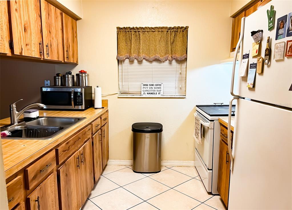 366 Diamond Street Deltona, FL 32725 - Photo 18 of 24 a kitchen with a refrigerator and a stove