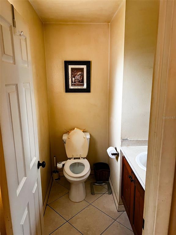 366 Diamond Street Deltona, FL 32725 - Photo 24 of 24 a bathroom with a granite countertop toilet and a sink