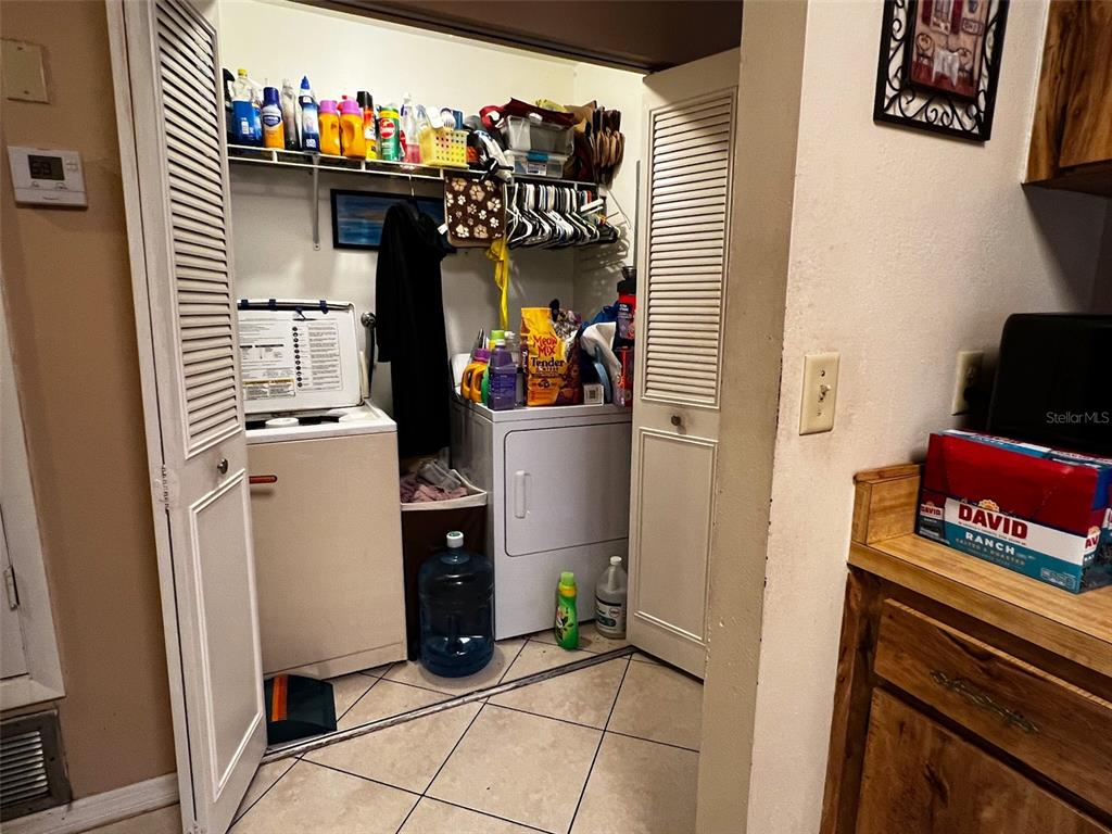 366 Diamond Street Deltona, FL 32725 - Photo 10 of 24 a view of a kitchen with fridge and rack