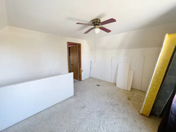 a view of room with a ceiling fan and window
