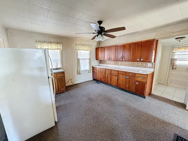 a kitchen with stainless steel appliances granite countertop a refrigerator a sink a stove a microwave a counter space and cabinets