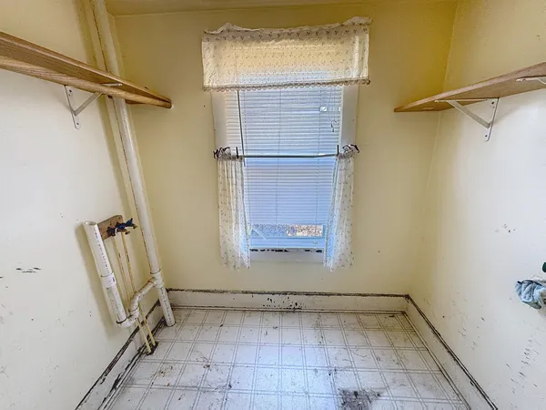 a view of a room with rack on the wall and a glass door shower