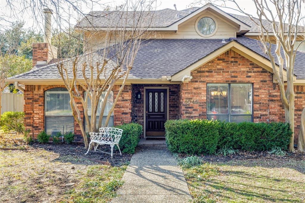 a view of house with yard and outdoor seating