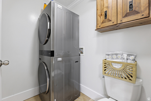 2342 Charros Road Sandy, UT 84092 - Photo 34 of 94 Laundry area featuring a stacked washer and dryer, wood-finish cabinetry, and clean white walls
