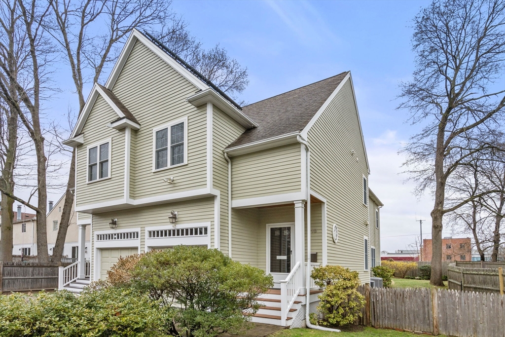 18 Maple Court, Unit 18 Needham, MA 02492 - Photo 1 of 25 a front view of a house with a yard