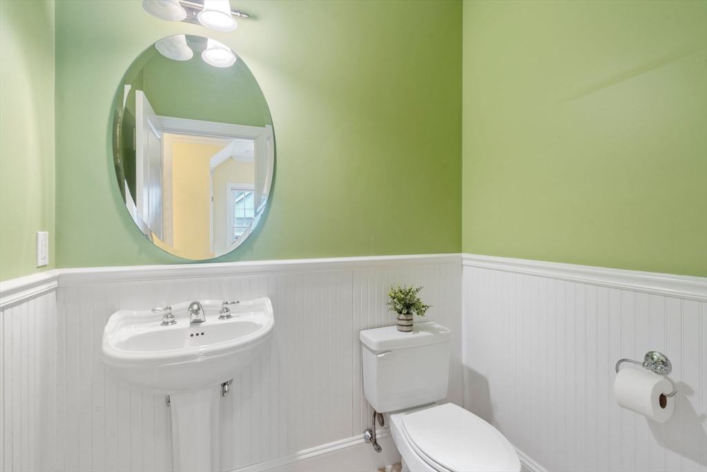 18 Maple Court, Unit 18 Needham, MA 02492 - Photo 13 of 25 a bathroom with a sink mirror and toilet