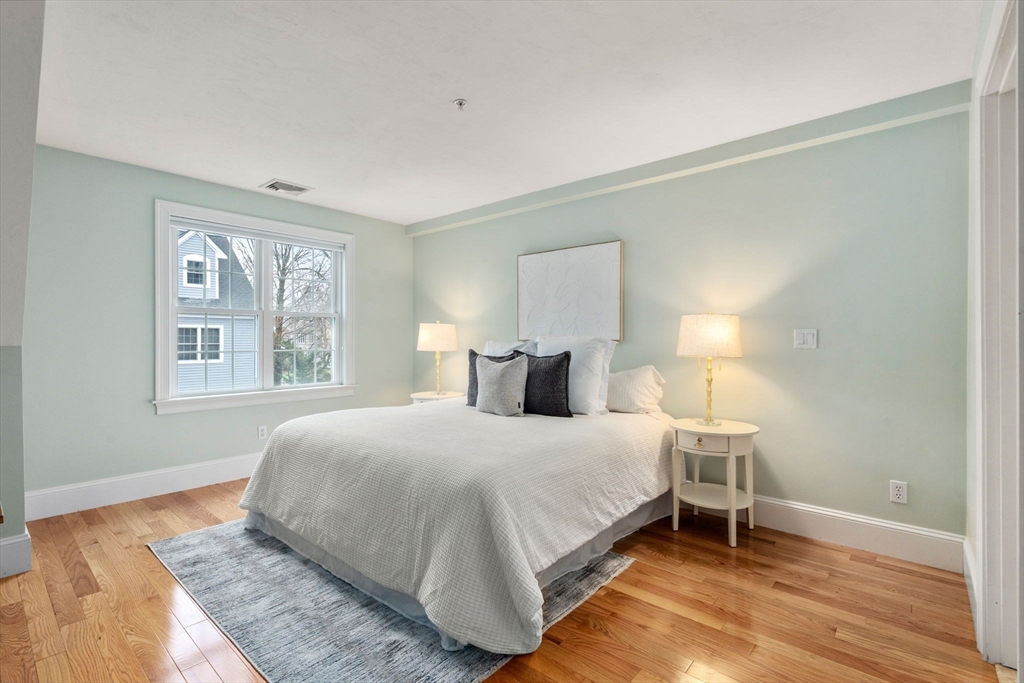 18 Maple Court, Unit 18 Needham, MA 02492 - Photo 14 of 25 a bedroom with a bed and a window