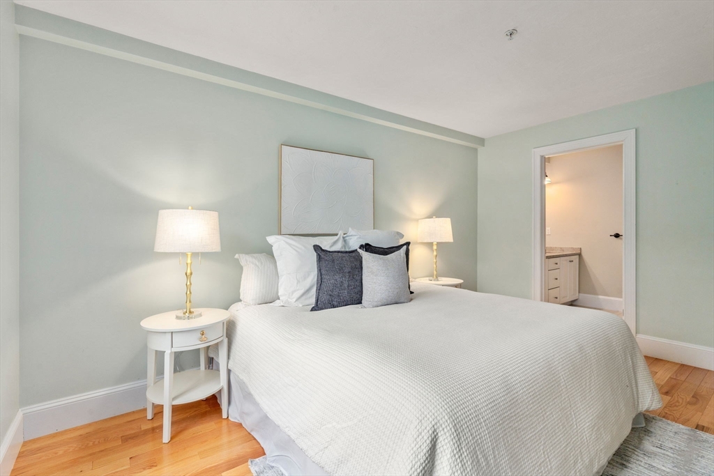 18 Maple Court, Unit 18 Needham, MA 02492 - Photo 15 of 25 a bedroom with a bed and a lamp