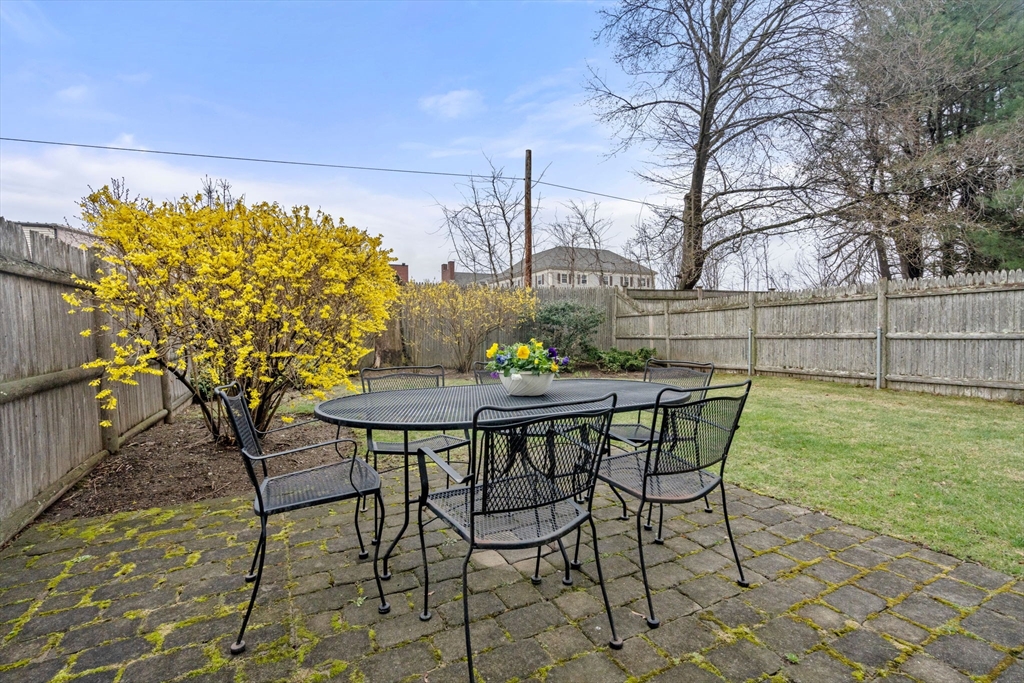 18 Maple Court, Unit 18 Needham, MA 02492 - Photo 21 of 25 a view of a chairs and table in the patio