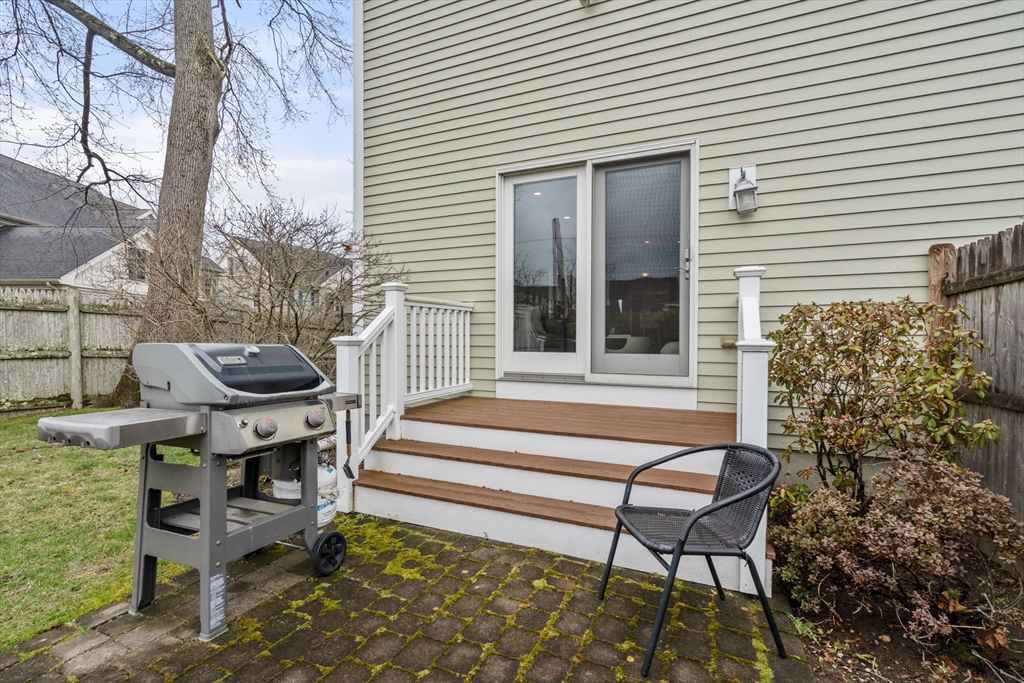 18 Maple Court, Unit 18 Needham, MA 02492 - Photo 22 of 25 a view of a chairs in a patio